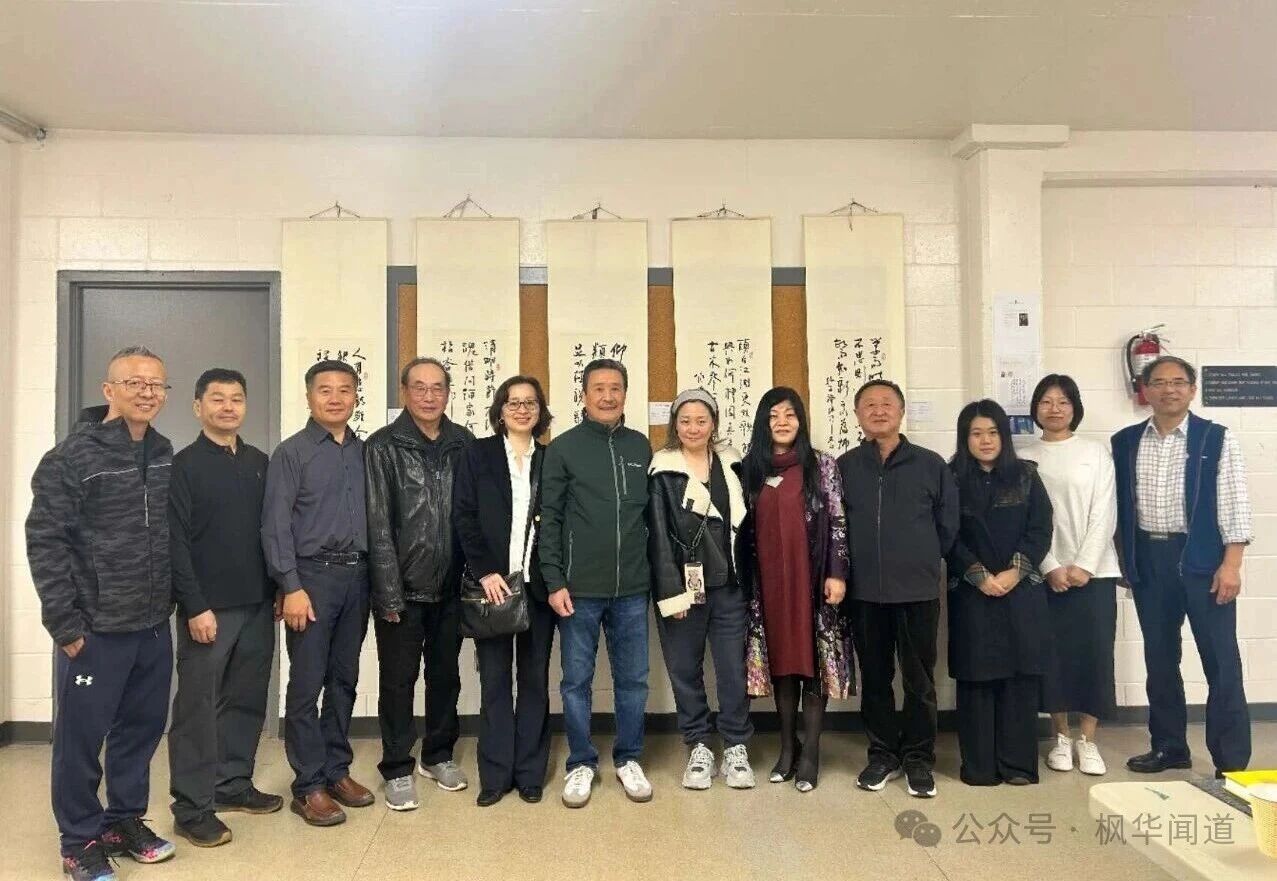 Calligraphy friends posing in front of works in the exhibition hall