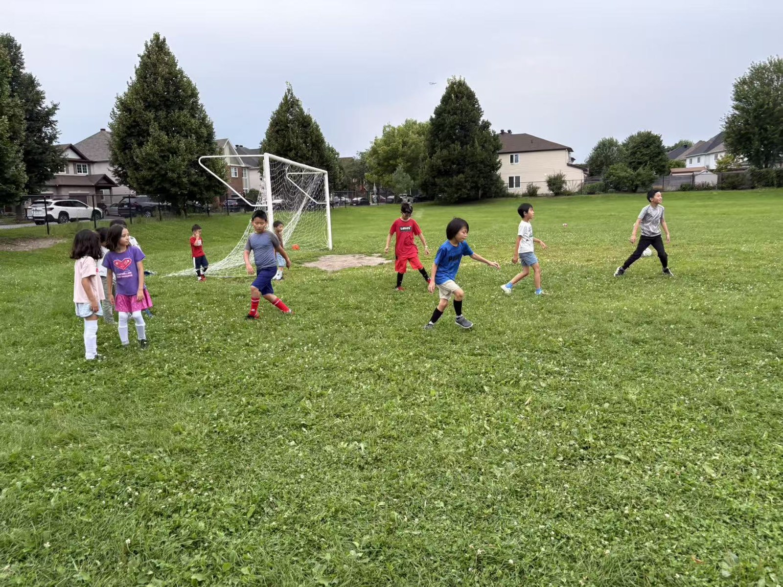 Children running and passing on the soccer field