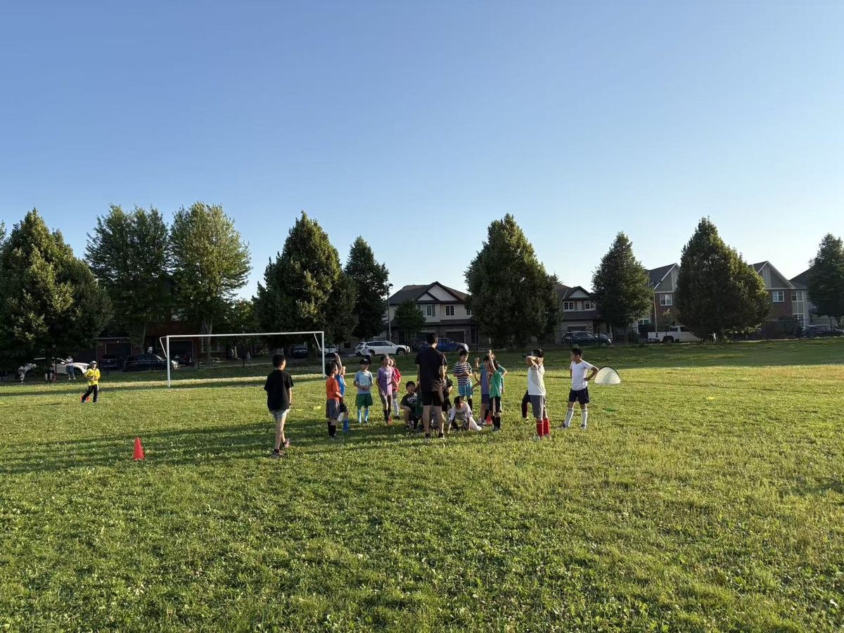 Children training in groups on the soccer field