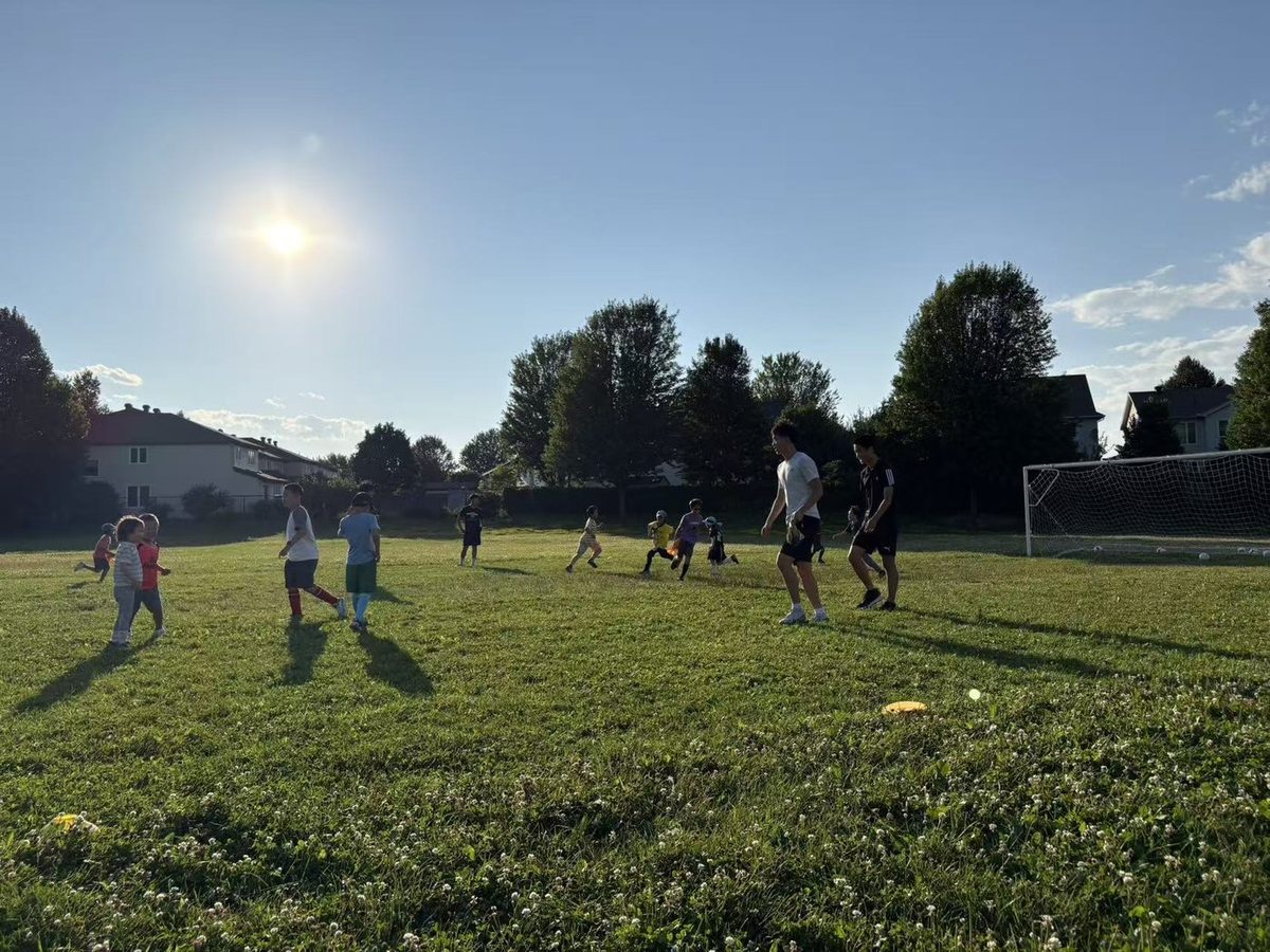 Coaches and children playing a small-sided soccer match