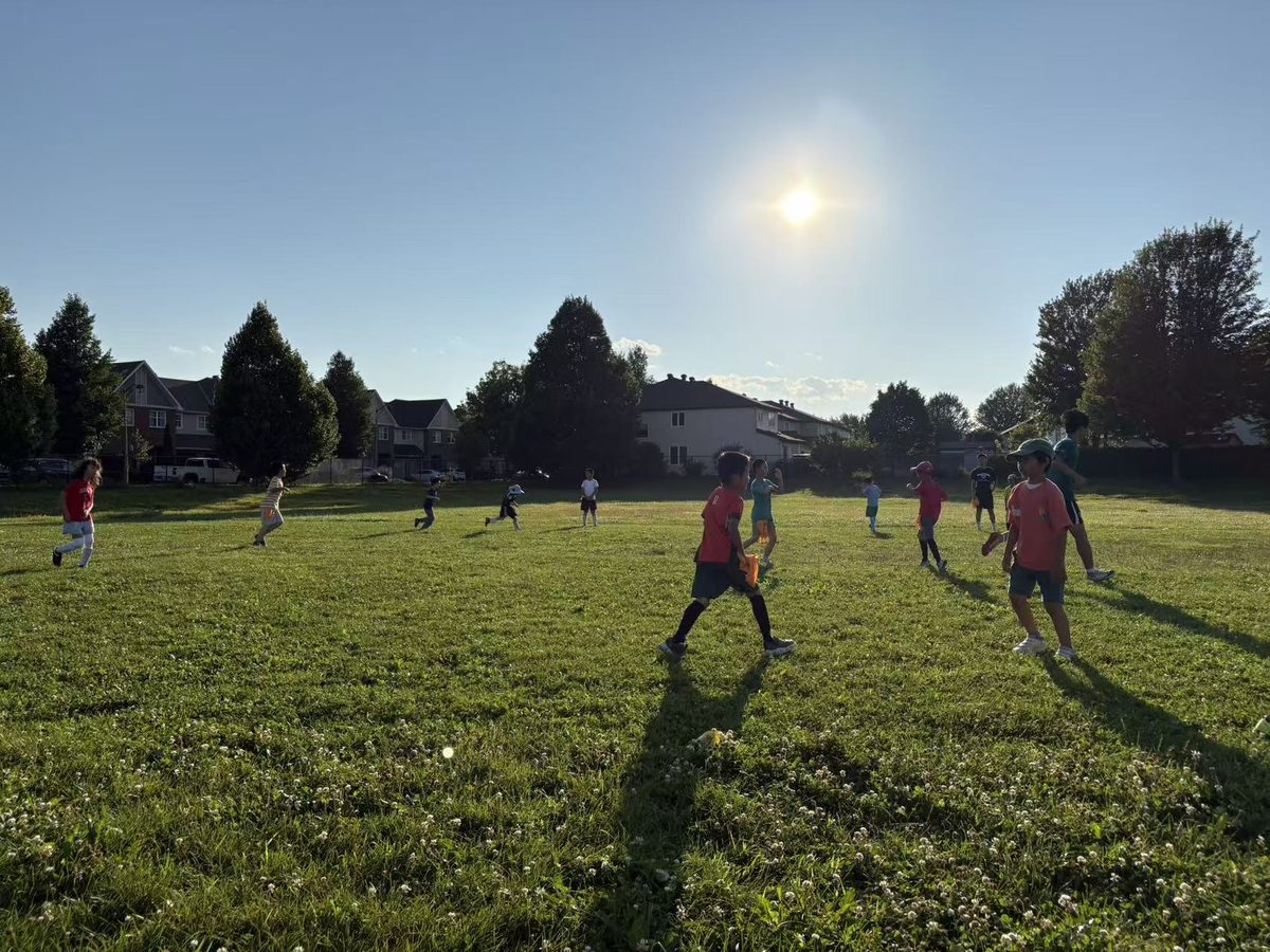 Young players enjoying a soccer match in the evening sunshine