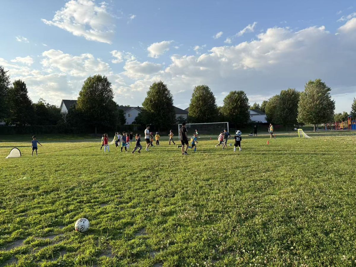 Children and coaches playing soccer together on July 15, 2026