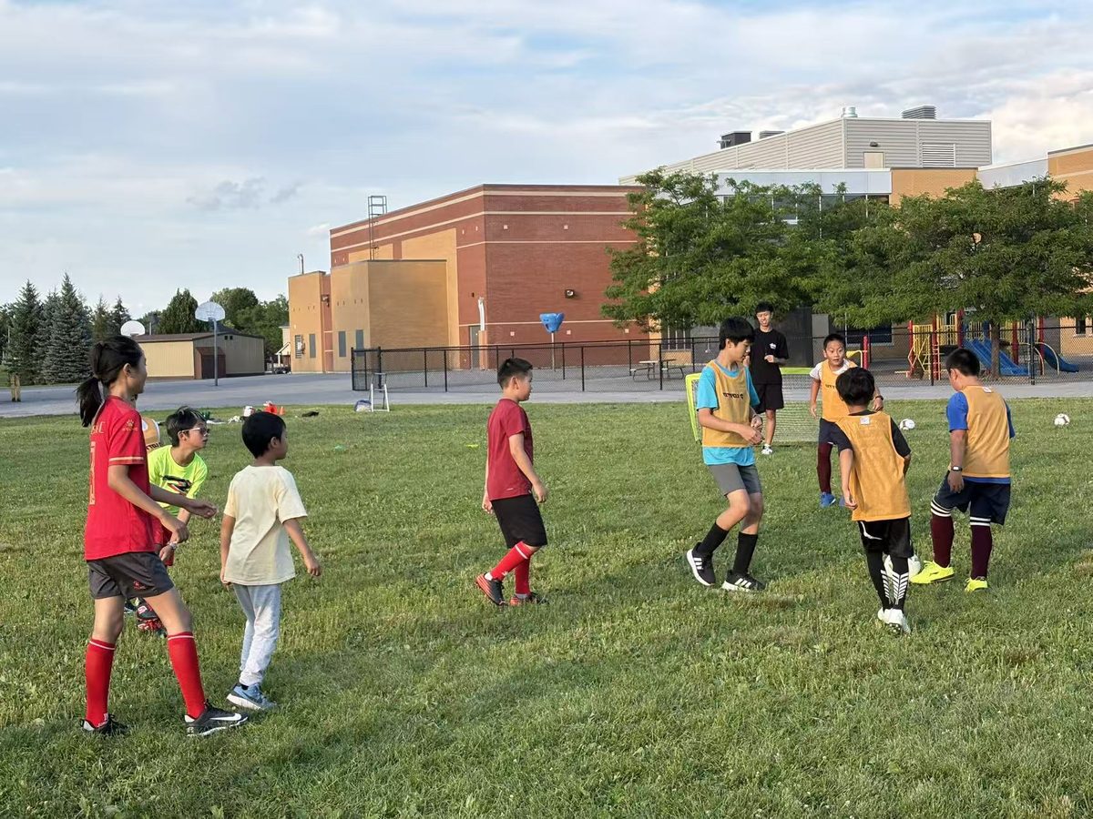 Coaches and children playing the final full soccer match